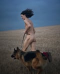 Charlie Gilmour, naked, running on the South Downs with his dog, Khan