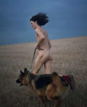 Charlie Gilmour, naked, running on the South Downs with his dog, Khan