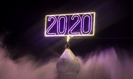 An illuminated sign reading “2020” is seen as waves hit the beach of Gaza shore ahead of new year celebrations in Gaza City, 