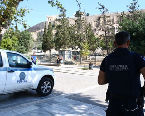 Police officers secure the area near the entrance to the Acropolis archaeological site in Athens, Greece, after a man allegedly stabbed two people.