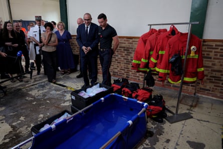 France’s interior minister, Laurent Nunez (centre), looks at an emergency cooling bath during a visit to a fire station