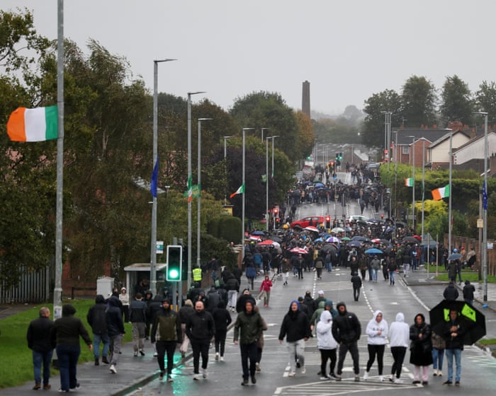 Former Sinn Fein leader Gerry Adams arrives at Orange Order protest after DUP accuses the party of 'breaking the law' by joining blockade - as demonstrator hurls bottle at police car