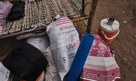 A pile of belongings next to a bedframe