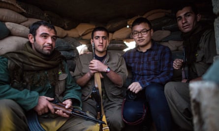 Chen Xu, a 29-year-old correspondent from China’s state-run news giant Xinhua, poses for a photo with Kurdish fighters battling Islamic State in northern Iraq.