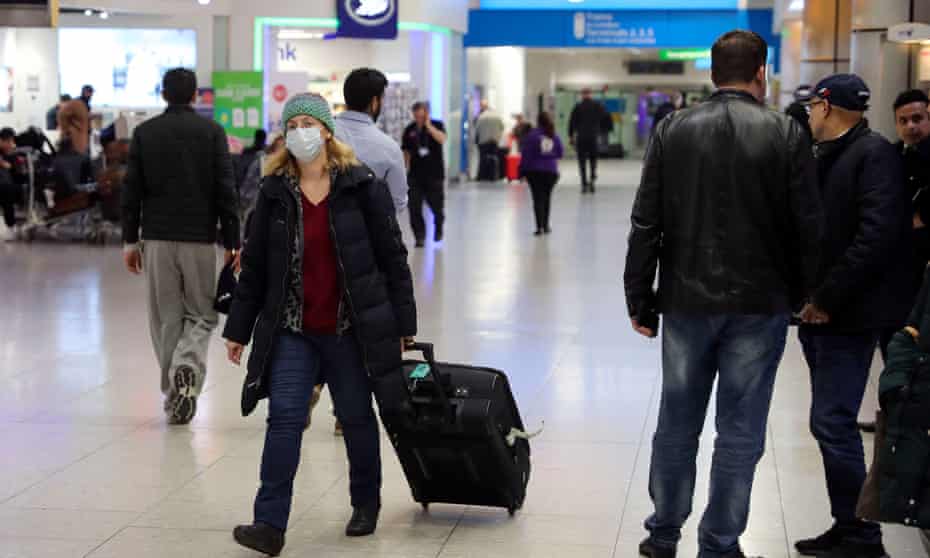 A traveller wearing a face mask at Heathrow airport