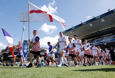 The teams take to the field at HBF Park in Perth, with mascots carrying their flags