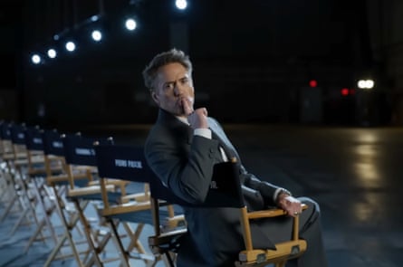 Robert Downey in a director’s chair in a movie theatre.