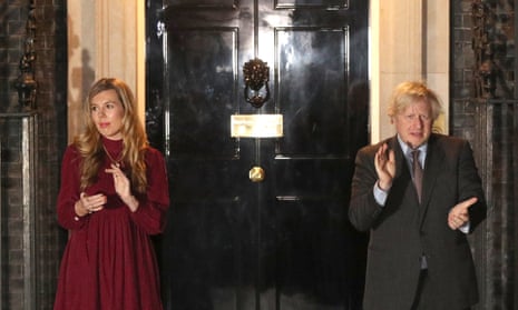 Prime Minister Boris Johnson and his partner Carrie Symonds outside 10 Downing Street join in with a nationwide clap in honour of Captain Sir Tom Moore.