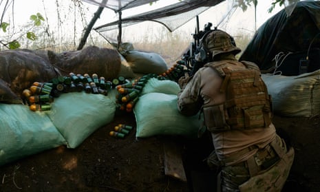 Ukrainian soldiers fire grenades towards Russian forces from a trench on the frontline near Donestk.