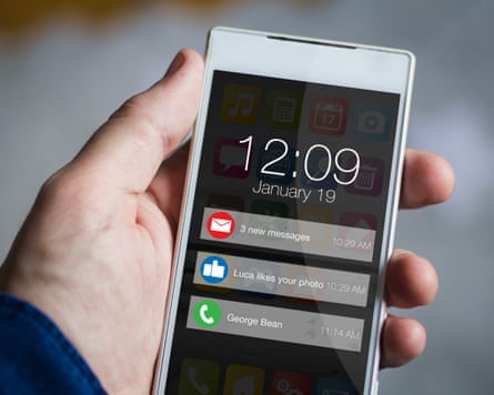 A man’s hand holding a smartphone with notifications. All screen graphics are made up.