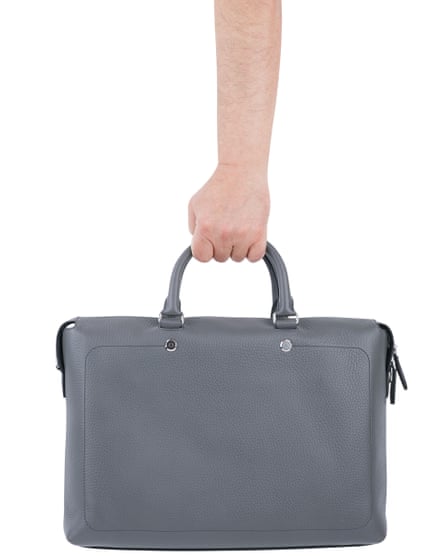 A man’s arm holding a grey briefcase against a white background.