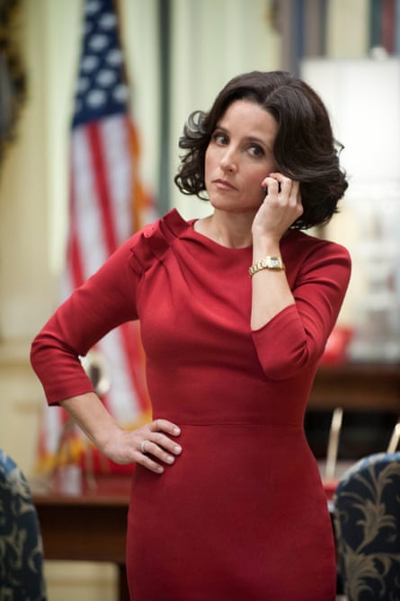 A woman wearing a red dress as she puts one hand on her hip and one on her face