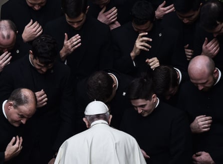 Pope Francis praying with priests at the end of a limited public audience in the Vatican in September 2020 during the Covid-19 outbreak.