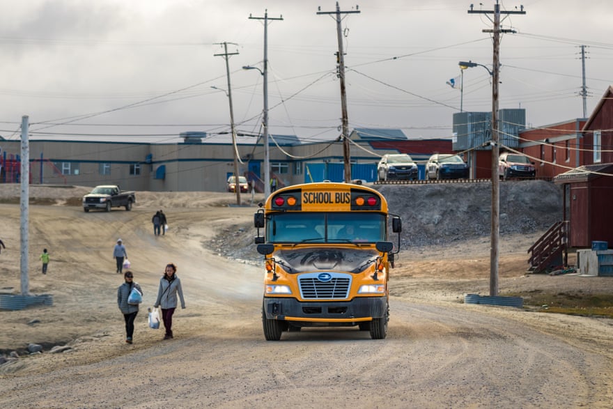 A school bus on a dirt road in Nunavut, Canada.