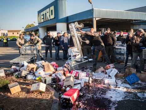 French vintners smash bottles of wine on the parking lot of a hypermarket in Caissargues, southern France.