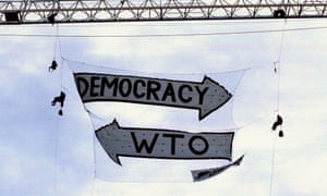 Members of the Rainforest Action Network drop a banner, protesting the World Trade Organization meetings in Seattle 1999.
