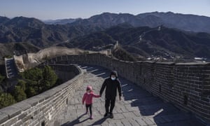 A Chinese man and his daughter wear protective masks as they walk on a nearly empty section of the Great Wall on 27 March, 2020 near Badaling in Beijing, China.