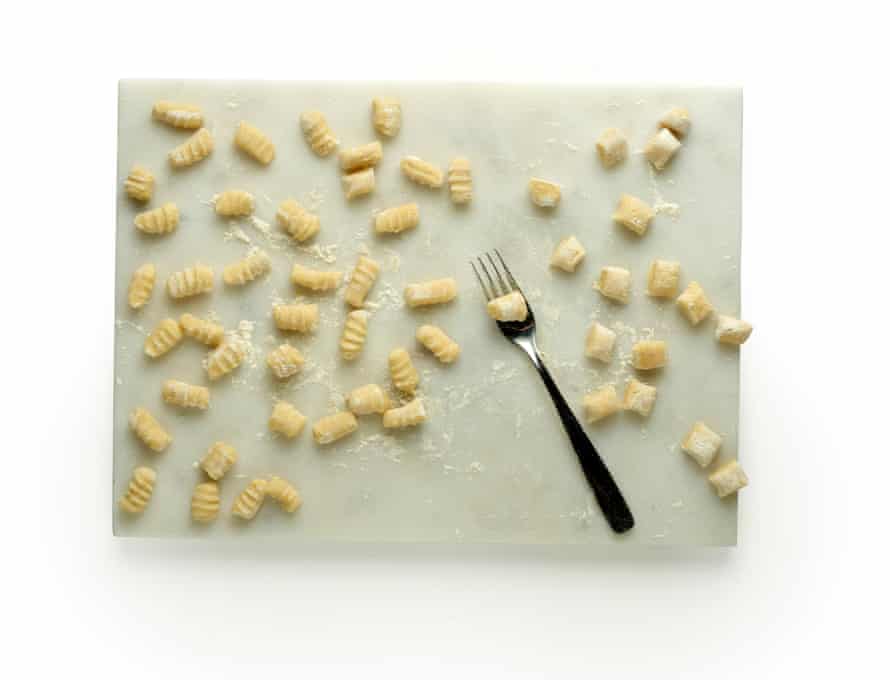 Felicity Cloake’s gnocchi masterclass, step 11: cut the rolls of dough into gnocchi. then roll each dumpling over the back of a fork to make grooves.