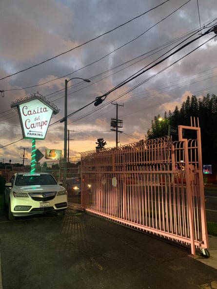 A car parked outside a sign for Casita del Campo, written in cursive