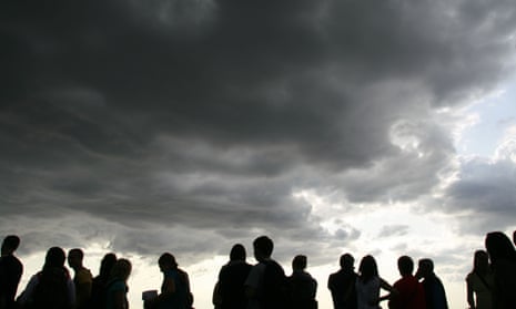 silhouette of many people against dramatic dark sky