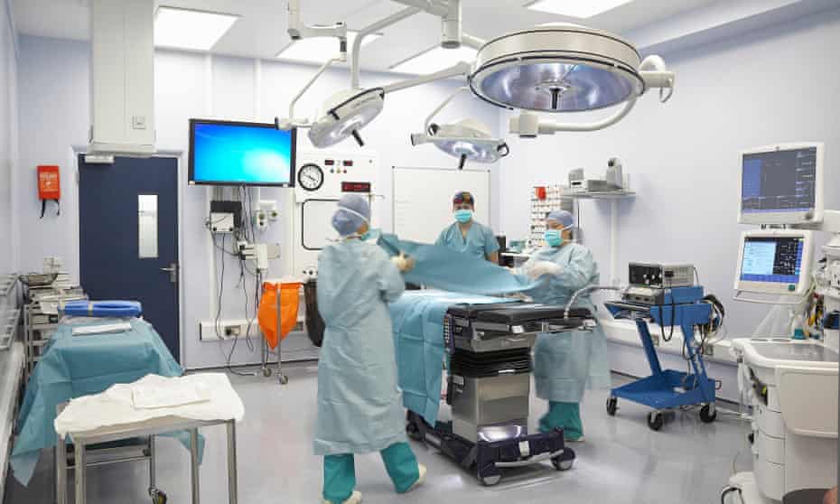 Preparing for surgery in an operating theatre in a hospital in the UK.