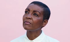Head shot of actor Adjoa Andoh in white shirt against pink background