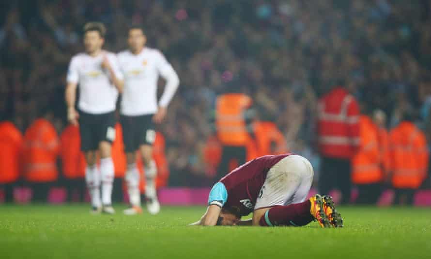 Mark Noble falls to the ground at the final whistle.
