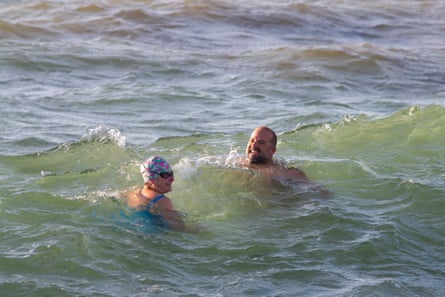 Jem Wallis and Glyn Winchester in the sea at Swanpool beach.