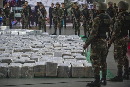 Police officers guard seven tons of seized cocaine in Lima, Peru. The drugs originated in Mexico and were bound for Europe.
