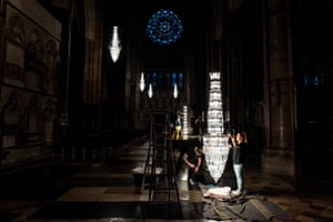 Technicians replace individual pieces of glass during a chandelier cleaning session at Westminster Abbey
