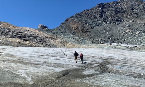Hikers walk across the Chessjen glacier in Switzerland