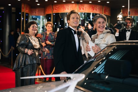 Glitzy event with people in 80s evening dress outside a venue