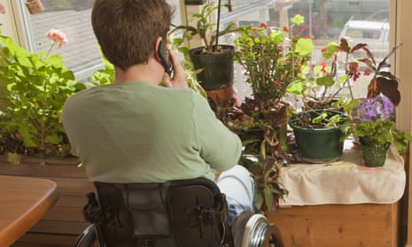 Woman in a wheelchair talking on a mobile phone.