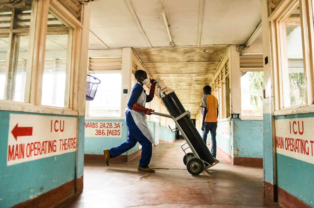 A health worker rushes an oxygen cylinder to a Covid-19 ward at Queen Elizabeth Central hospital in Blantyre.
