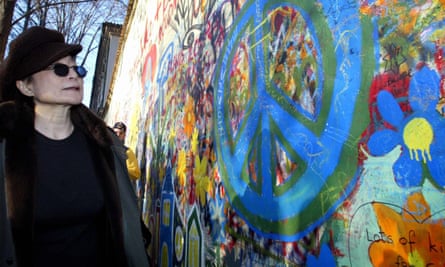 Yoko Ono, John Lennon’s widow, stands by the Lennon wall.