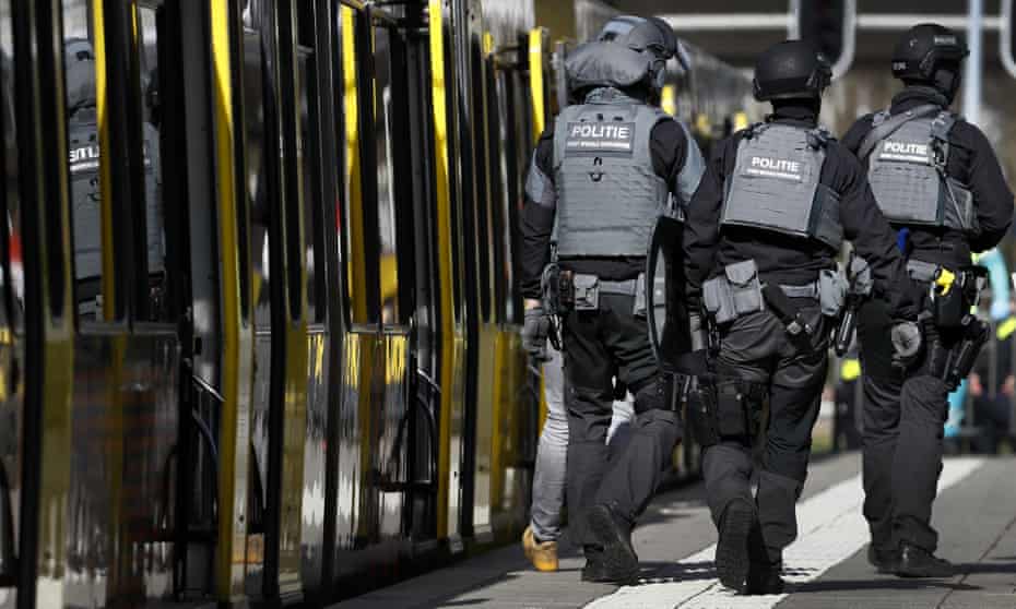 Dutch police officers walk near a tram in Utrecht