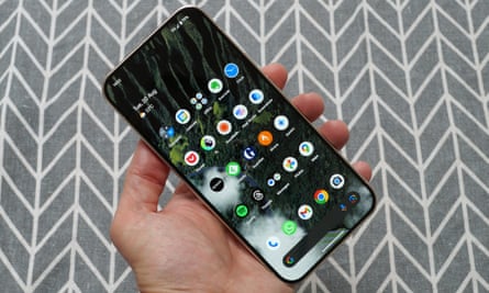 A Google Pixel 9 Pro XL being held showing the home screen.