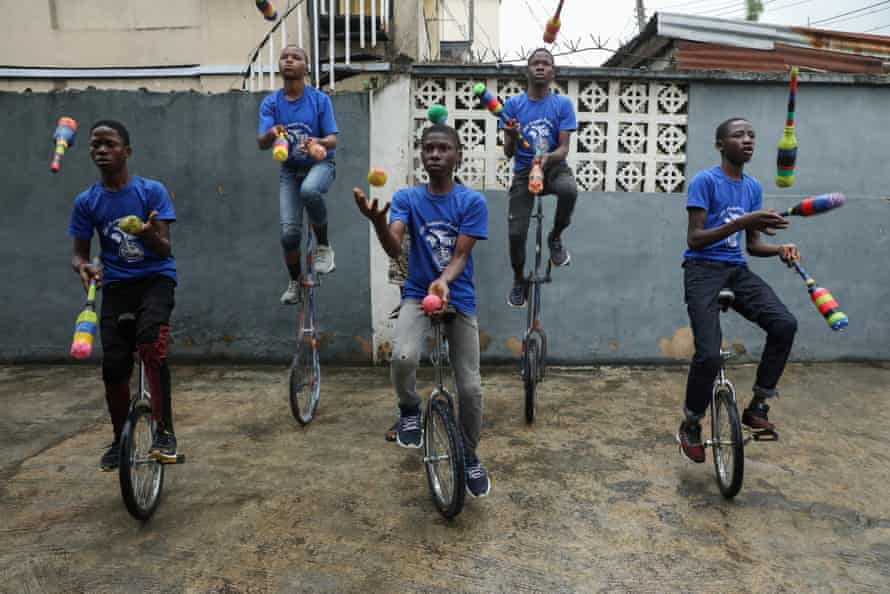 Members of the GKB academy, a unicycle club, juggle during a training session in Lagos, Nigeria, 11 October