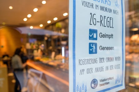 A sign showing indoor dining only for “2G” - the term in German for people who are either vaccinated against (geimpft) or recovered from (genesen) coronavirus, hangs at the entrance to a cafe in Leipzig.