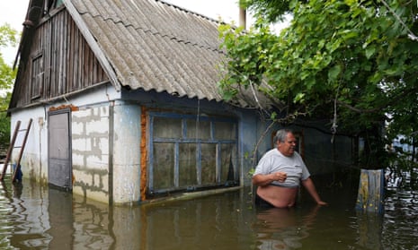 Yuriy, a 56-year-old Ukrainian farmer stands chest-deep in water in his village of Afanasiyivka, Mykolaiv region after destruction of the Kakhovka hydroelectric dam.