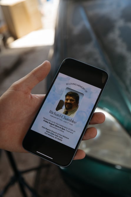 a person holds a phone showing an invitation with a photo of a man