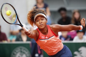 Naomi Osaka stretches for a return.
