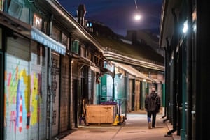 A man walks past closed market stalls