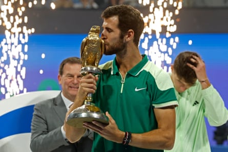 Karen Khachanov kisses his trophy after winning the Qatar Open.