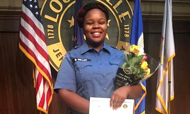 Breonna Taylor, an EMT, poses during a graduation ceremony in Louisville, Kentucky.