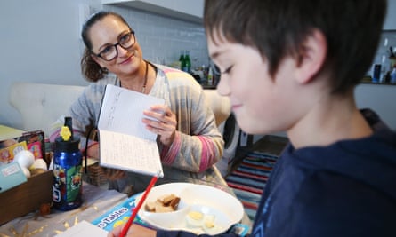 Donna Eddy helps son Phoenix at their home in Sydney. Supporting wellbeing also means accepting neither adult or child might complete a full day’s workload, says Pasi Sahlberg.