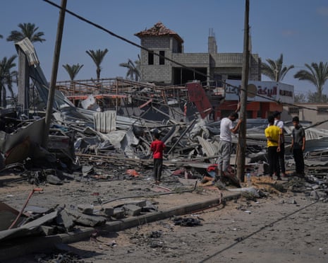 Palestinians inspect the wreckage of a gas station destroyed in an Israeli airstrike in Deir al-Balah, central Gaza Strip on Saturday, 12 July 2025.