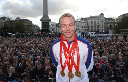 Chris Hoy wearing 3 golden medals successful Trafalgar Square pinch a crowd successful nan background