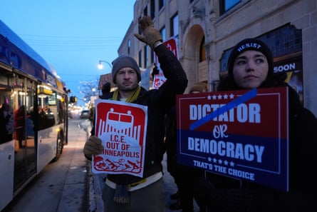 People hold up signs at protest