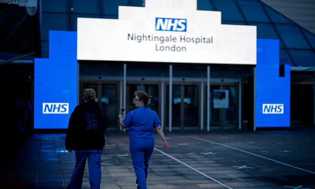 Medical staff outside the Nightingale hospital in the ExCeL centre, London.